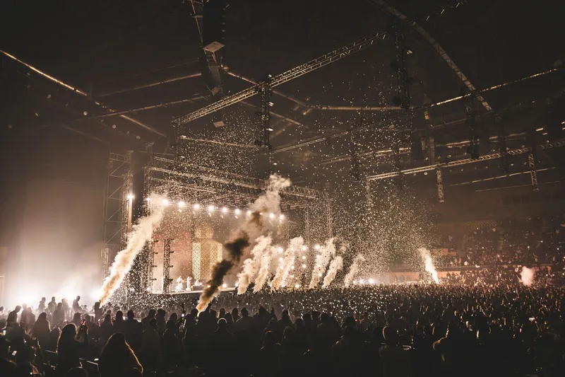 Crowd at a live concert with stage pyrotechnics